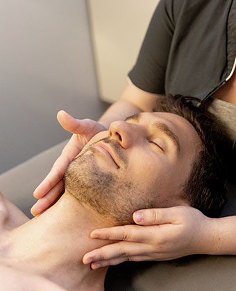 man getting face massage at Exhale
